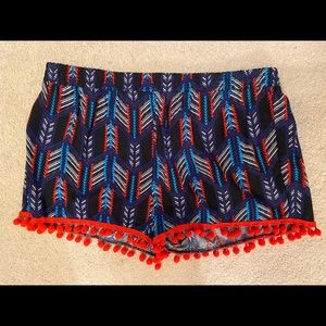 Shorts with red balls at the bottom